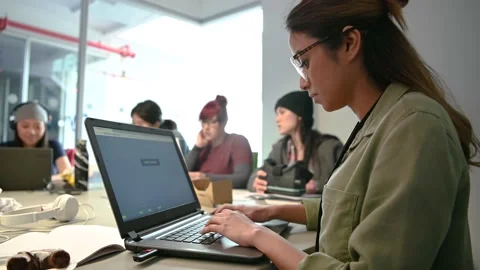 Focused female computer programmer working at laptop in conference room Stock Footage 220346095