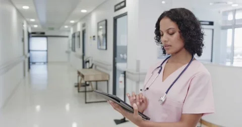 Focused female doctor using tablet in hospital in slow motion Stock Footage 336714723