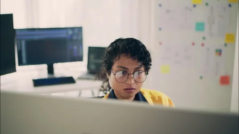 Focused female engineer working with AI on a computer. Stock Footage 319001763