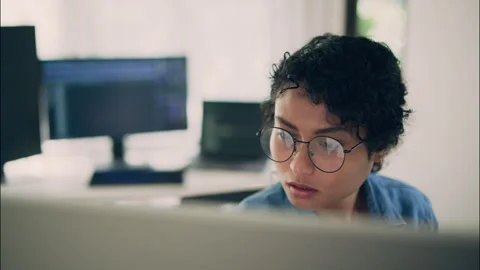 Focused female programmer working on AI and computer technology. Stock Footage 319001699