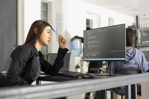 Focused Female Software Engineer at Computer Desk Stock Photos