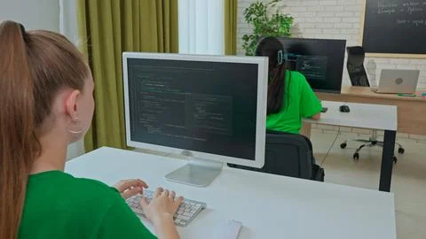 Focused Female Student Programming on Computer in Classroom Stock Photos