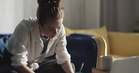 Focused female student taking notes and doing homework Stock Footage 172147055
