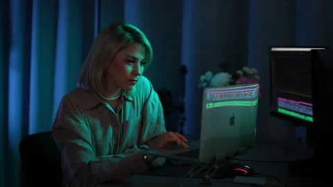 Focused female videography expert editing video footage in post production home Stock Footage 280105437