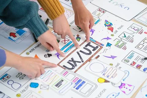 Focused female web developer is planning application for smart phone on whi.. Stock Photos