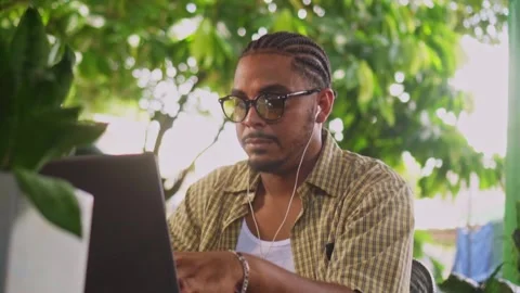 Focused freelancer with eyeglasses working on laptop outdoors Stock Footage 344761114