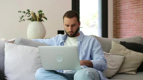 Focused freelancer man working remotely on laptop 스톡 동영상 335588528