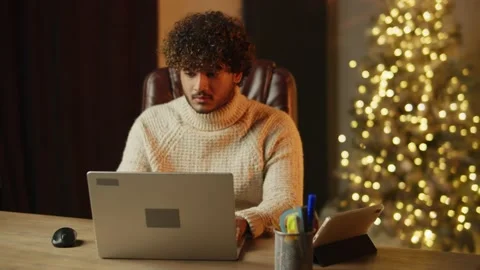 Focused freelancer typing on laptop keyboard and showing success gesture Stock Footage 232884677