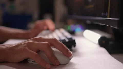 Focused Gaming Hand on the Computer Mouse in a Soft, Ambient Light Setting that Stock Footage 315138900