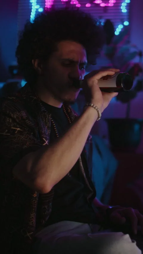 Focused Gen Z Developer Working on Laptop and Drinking Beer Stock Footage 291241801