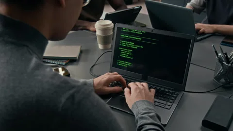 Focused Gen Z Male Programmer Coding on Laptop at Office Desk Stock Footage 329611418