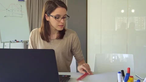 Focused girl opens journal at the table Video stock 311981201