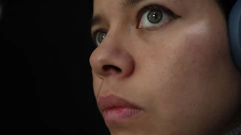 Focused Girl Using Computer with Headphones in Close-up Stock Footage 337488599