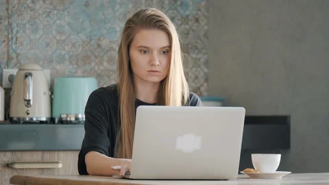 Focused girl using computer for study online at home. Self isolation concept. Stock Footage 129957294