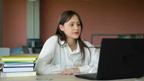 Focused girl using laptop in class, attractive female student learning language Stock Footage 243322610
