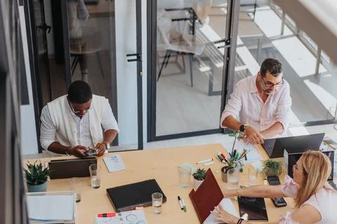 A focused group analyzes statistics, works on e-commerce, and collaborates in a Stock Photos