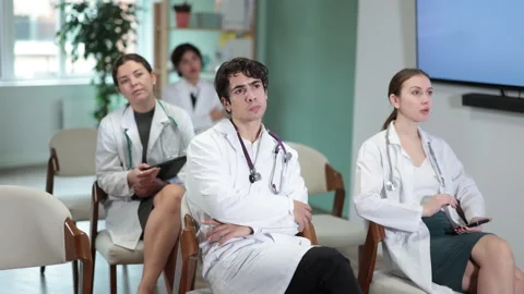 Focused group of medicals students sitting on chairs and listening lecture Stock Footage 332644131