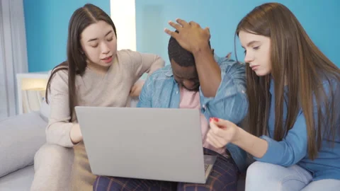 Focused group of young people trying to solve a problem. They is looking at the  Video stock 228802816