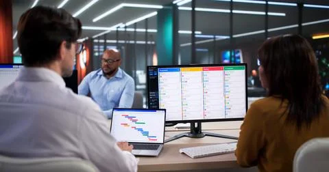 Focused Group Of Young Professionals Using Computer Software To Efficiently O Stock Photos