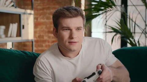 Focused guy playing videogame in weekend Stock Footage 160033580