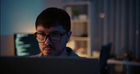 Focused Hacker or Programmer Working Late on Computer in Dark Office. Stock Footage 306738779