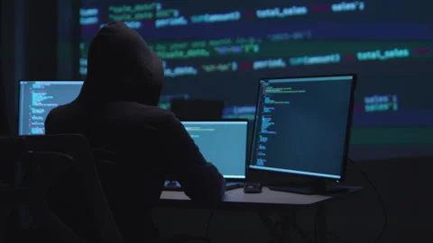 Focused Hacker Programming with Multiple Screens Displaying Code and Cybers.. Stockbeeldmateriaal 336679077