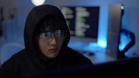 Focused hacker writing code during cyber operation Stock Footage 313824945