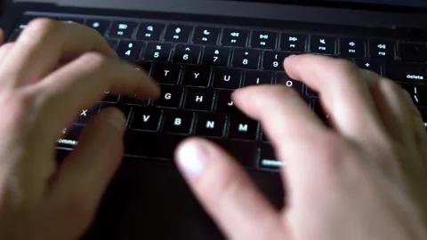 Focused hands complete work on a modern laptop keyboard Video stock 332599547