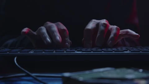 Focused Hands Typing on Keyboard in a Dimly Lit Environment or Room Stock Footage 281759675