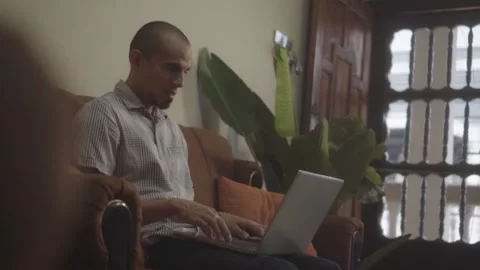Focused hispanic man typing on laptop computer Видео 341892657