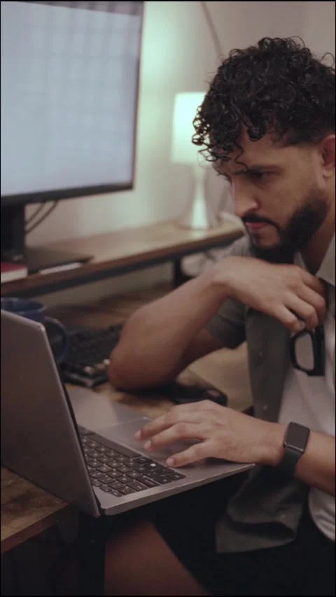 Focused hispanic professional typing on laptop at night Stock Footage 341498278