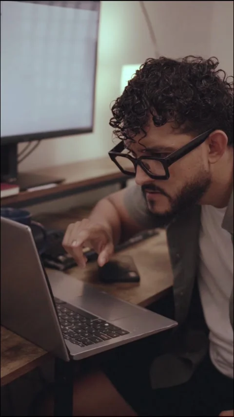 Focused hispanic professional typing on laptop computer Stock Footage 341498396