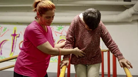 A focused image showing a care worker aiding a mental health residence patient, Stock Footage 331752811