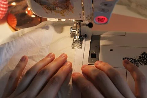 Focused Image of Skilled Hands Running a Sewing Machine Stock Photos