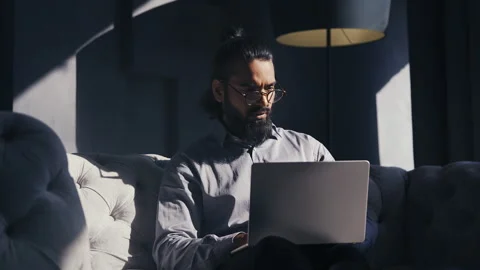 Focused Indian company head working on laptop and reading business documents Stock Footage 316837408