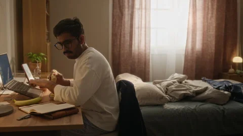 Focused Indian Freelancer Working on Laptop While Eating Breakfast at Home Stock Footage 337721881