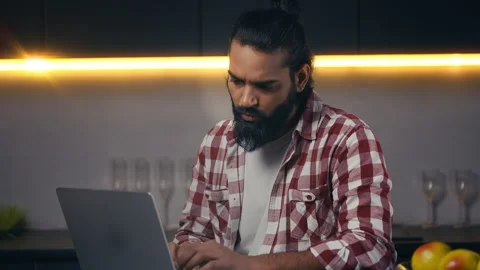 Focused Indian IT specialist working on project from home, typing on laptop Stockbeeldmateriaal 316836213