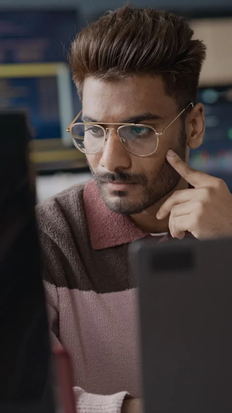 Focused Indian Male Programmer Analyzing Data on Computer in Office Video stock 337475242