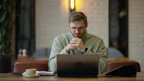 Focused Individual Contemplating Ideas While Seated at a Table with a Laptop Stock Footage 344799905