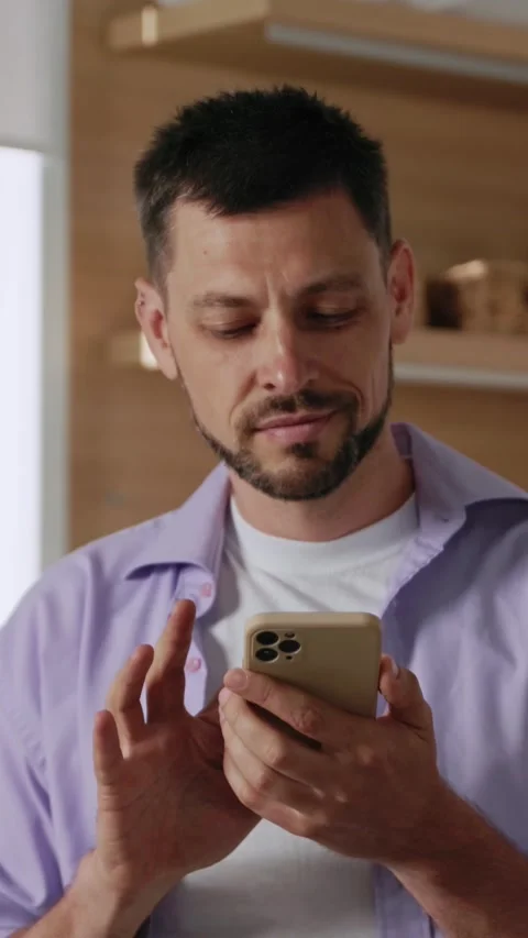A Focused Individual Engaging Actively with a Smartphone in a Modern and Stylish Stock Footage 314360292
