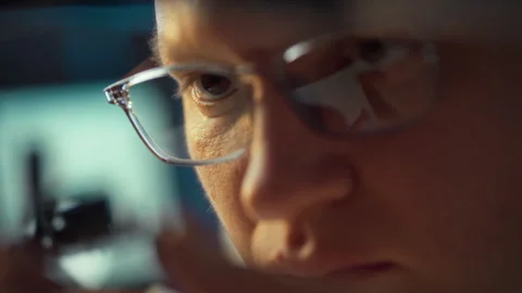 Focused individual examining details with intensity during a workshop Stock Footage 323805388