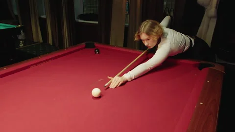 Focused individual performing carefully controlled shot on billiard table Video stock 329192973