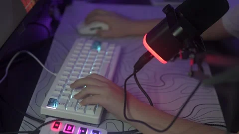 A focused individual types at a desk, highlighting tech in workflows Stock Footage 305647220