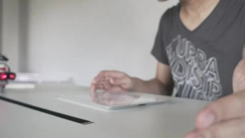 Focused Individual Using Tablet in Modern Workspace Stock Footage 315116019