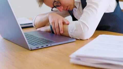 Focused individual working on laptop at a clean office desk Stock Footage 305177236
