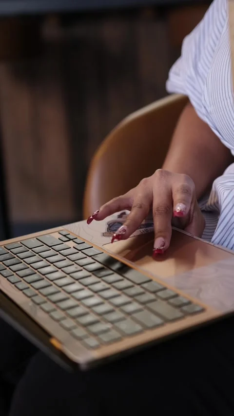 A focused individual working on a sleek laptop, embodying modern productivity 動画素材 306039780