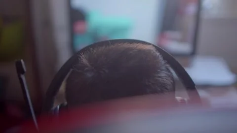 A focused individual works on a computer, immersed in their task Stock Footage 311117463