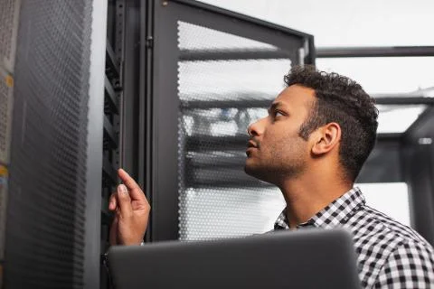 Focused IT guy updating software Stock-Fotos