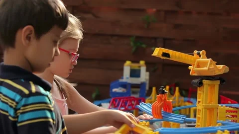 Focused Kids Building with a Plastic Construction Set Stock Footage 312468518
