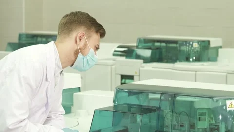 Focused lab technician operates a laboratory centrifuge Stock Footage 311991950